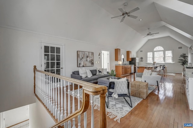 living room with vaulted ceiling and light wood-style floors