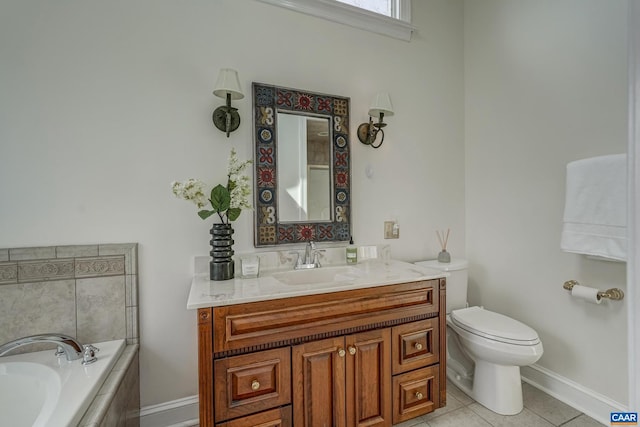 bathroom with a garden tub, toilet, tile patterned flooring, baseboards, and vanity