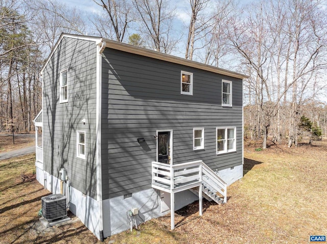 rear view of house with crawl space and cooling unit