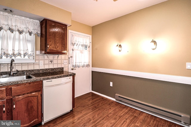 kitchen featuring dark wood-type flooring, a sink, dark countertops, white dishwasher, and a baseboard radiator