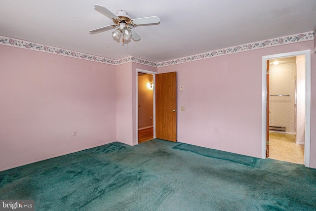 spare room featuring baseboard heating, a ceiling fan, and carpet floors