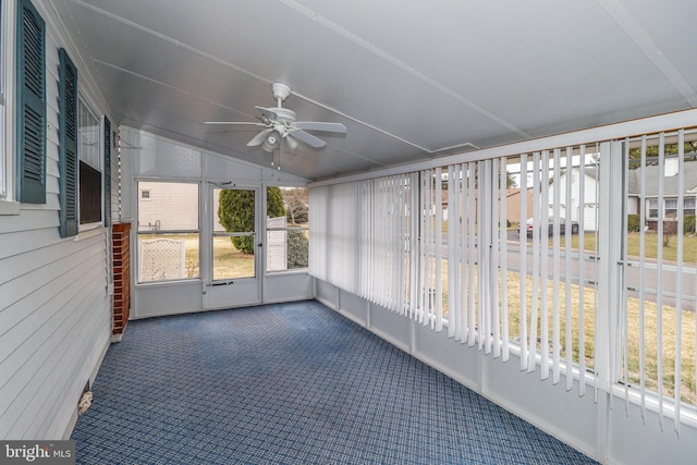 unfurnished sunroom with lofted ceiling and ceiling fan