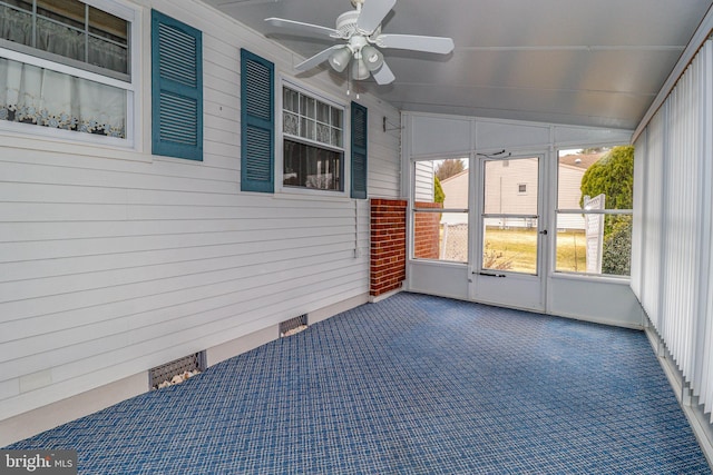 unfurnished sunroom with ceiling fan and lofted ceiling