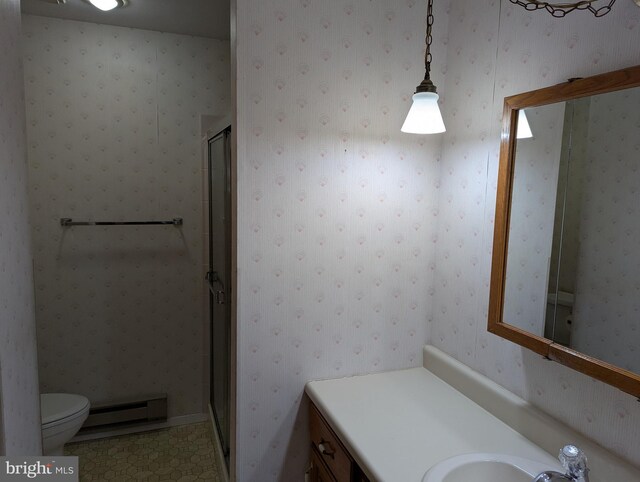 bathroom featuring a baseboard radiator, vanity, a shower stall, and wallpapered walls