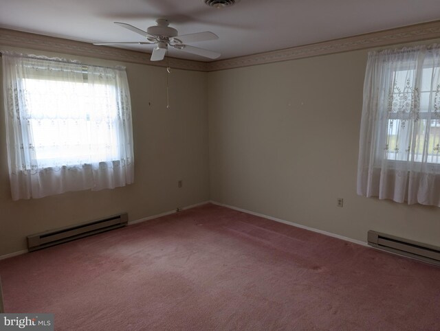 unfurnished room with a baseboard heating unit, a ceiling fan, baseboards, and carpet floors