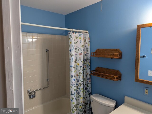 full bathroom with toilet and shower / bath combo with shower curtain