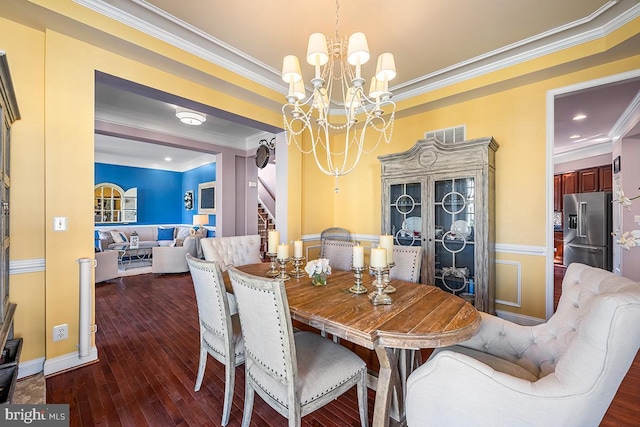 dining area featuring stairway, a notable chandelier, wood finished floors, and ornamental molding