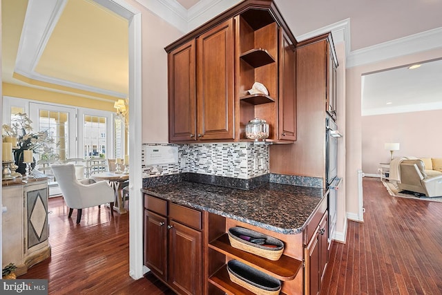 kitchen featuring dark wood finished floors, ornamental molding, backsplash, and open shelves