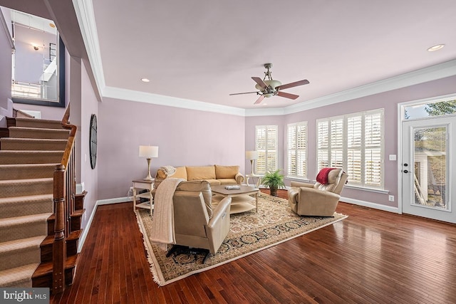 living area with stairway, crown molding, and hardwood / wood-style floors