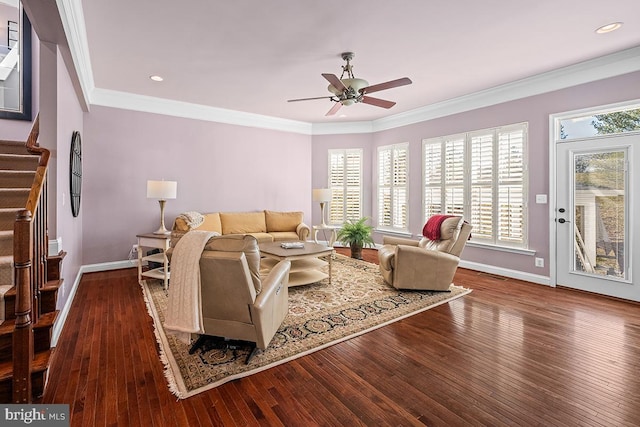 living area with stairway, crown molding, visible vents, and hardwood / wood-style floors