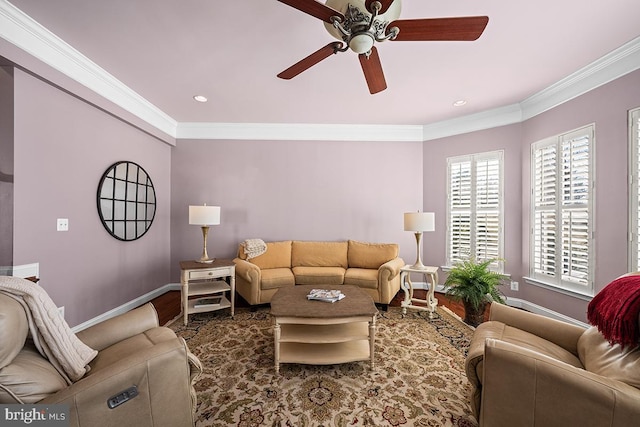 living area featuring wood finished floors, a ceiling fan, baseboards, and ornamental molding