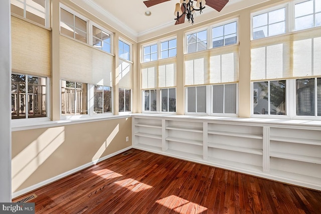 unfurnished sunroom with a ceiling fan