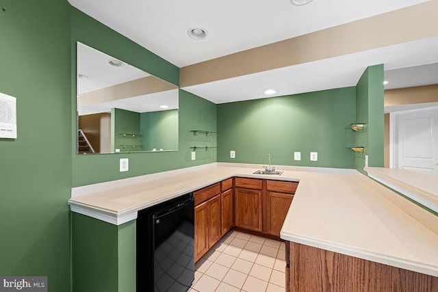 kitchen with light tile patterned floors, recessed lighting, a sink, light countertops, and fridge