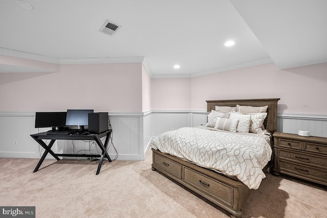 carpeted bedroom with recessed lighting, visible vents, a wainscoted wall, and ornamental molding