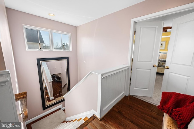 interior space with an upstairs landing, recessed lighting, and wood finished floors