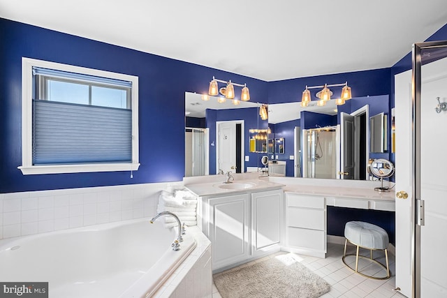 bathroom featuring tile patterned floors, vanity, a garden tub, and a shower stall