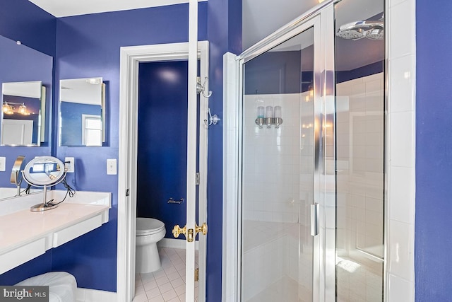 bathroom with tile patterned flooring, baseboards, toilet, a stall shower, and vanity