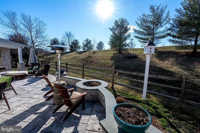 view of patio with a fire pit and fence