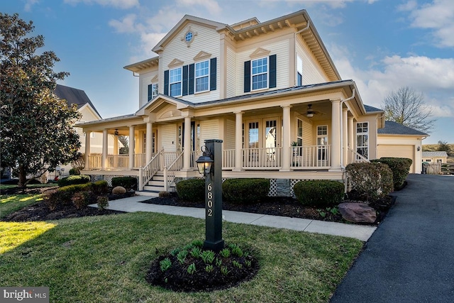 view of front of house with a porch, a front yard, and a ceiling fan