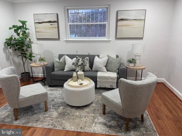 living area featuring wood finished floors and baseboards