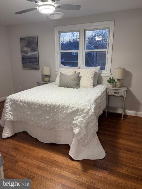 bedroom featuring a ceiling fan, wood finished floors, and baseboards