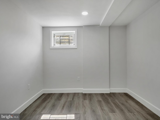 empty room featuring baseboards and wood finished floors