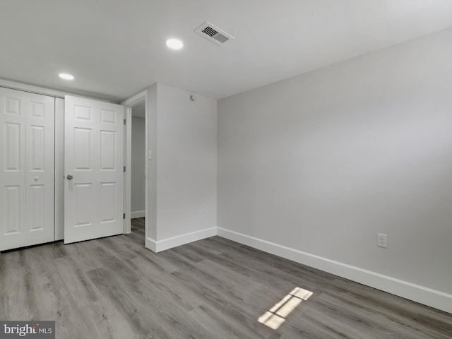 unfurnished bedroom with recessed lighting, visible vents, baseboards, and wood finished floors