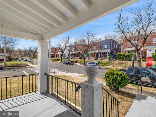 view of patio with covered porch and a residential view