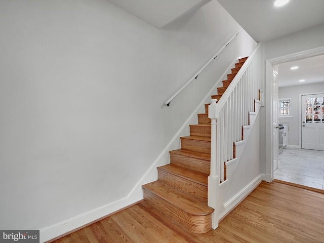 stairs featuring recessed lighting, baseboards, and wood finished floors