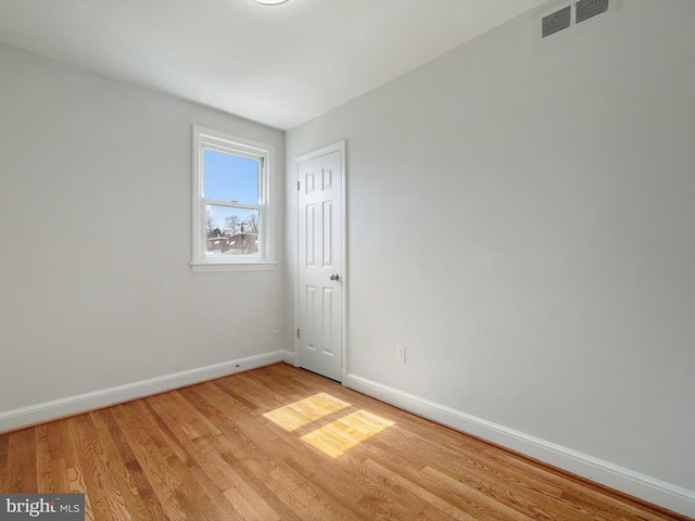 unfurnished room featuring visible vents, baseboards, and light wood-style flooring