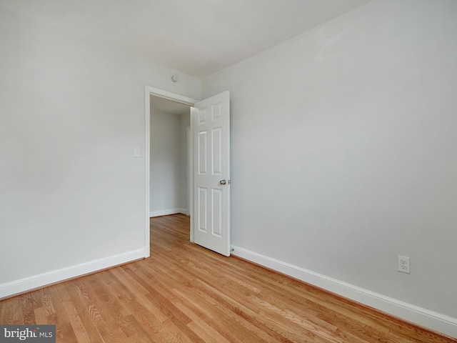 unfurnished room featuring light wood-type flooring and baseboards