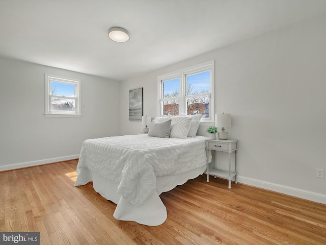 bedroom featuring light wood-style flooring and baseboards