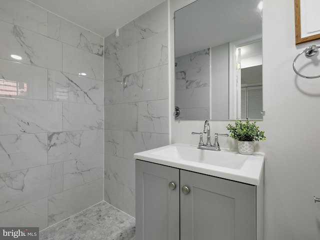 full bathroom with vanity and tiled shower