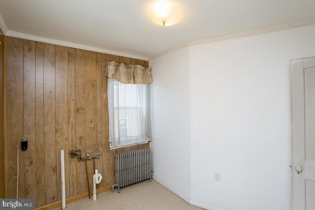 unfurnished room featuring crown molding, radiator heating unit, and baseboards