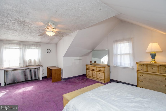 carpeted bedroom featuring multiple windows, radiator, vaulted ceiling, and a textured ceiling