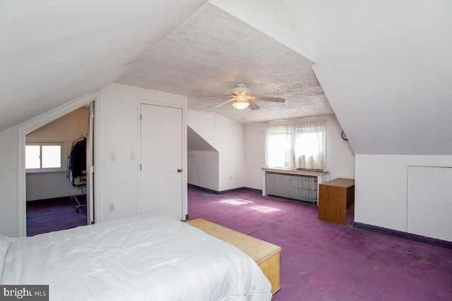 bedroom featuring lofted ceiling, radiator, carpet flooring, and a textured ceiling