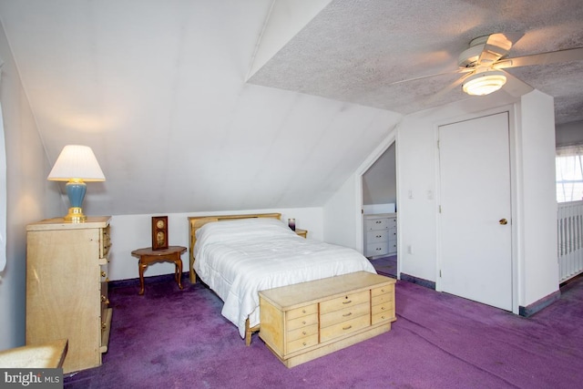 bedroom with vaulted ceiling, carpet flooring, baseboards, and a textured ceiling