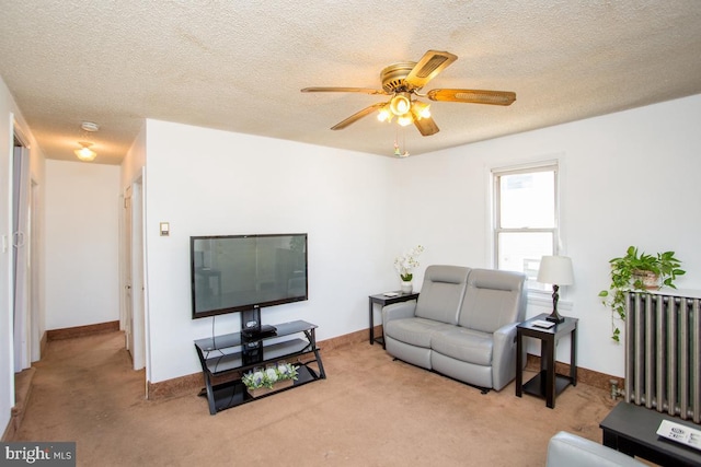 living room with carpet flooring, radiator, a textured ceiling, and ceiling fan