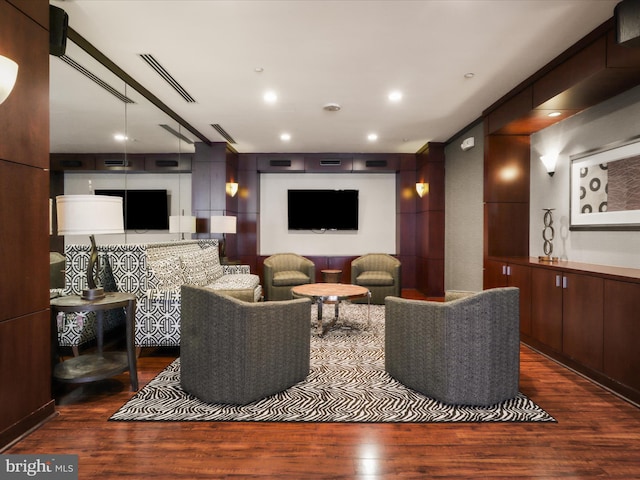 living room with recessed lighting, wood finished floors, and visible vents