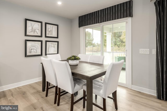 dining room featuring recessed lighting, baseboards, and light wood finished floors