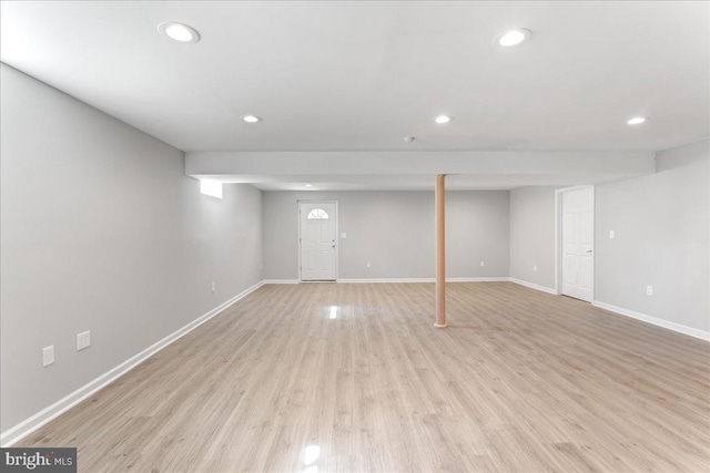 finished basement with recessed lighting, baseboards, and light wood finished floors