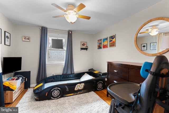 playroom with wood finished floors and ceiling fan