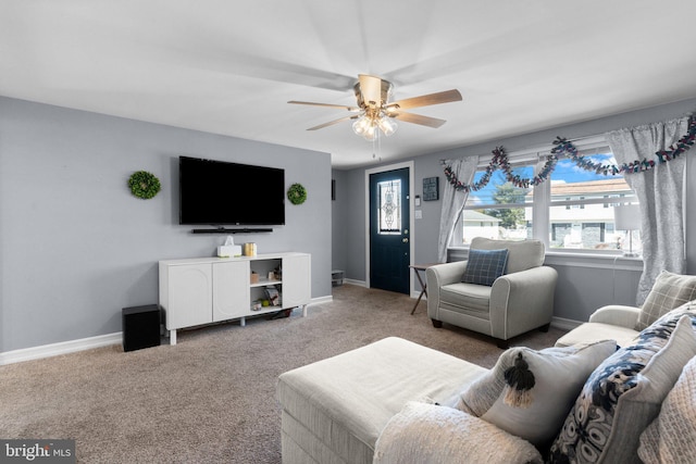 carpeted living area featuring baseboards and ceiling fan