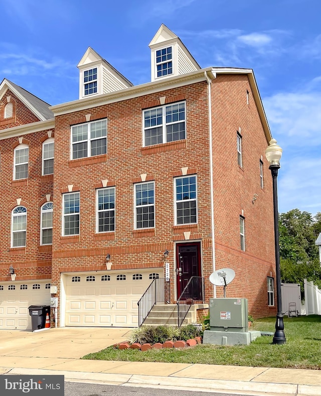 townhome / multi-family property featuring concrete driveway, a garage, and brick siding