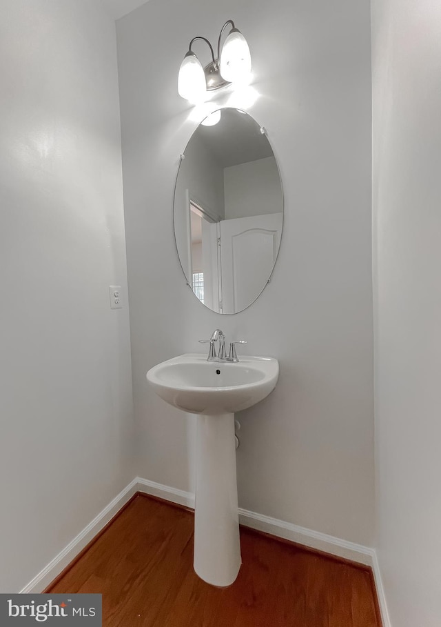 bathroom featuring baseboards and wood finished floors