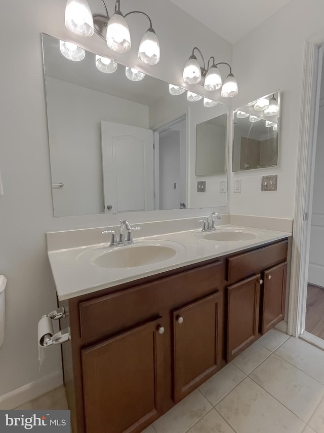 full bath with tile patterned flooring, double vanity, and a sink