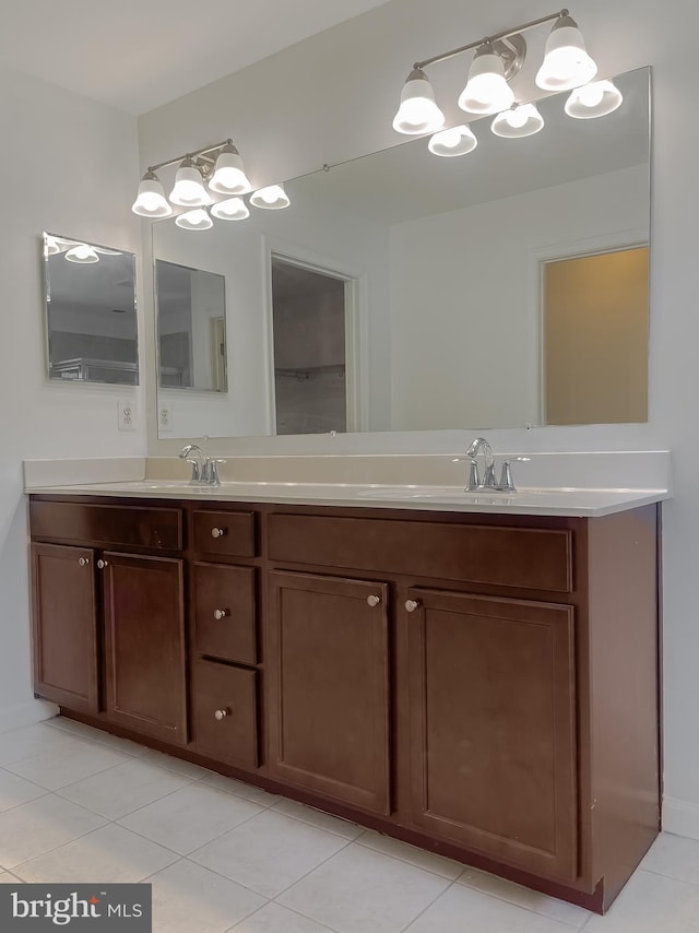 bathroom with double vanity, tile patterned floors, and a sink