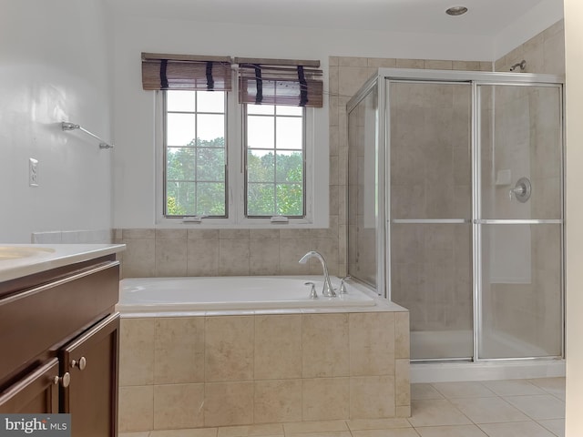 full bathroom with tile patterned flooring, a shower stall, a bath, and vanity