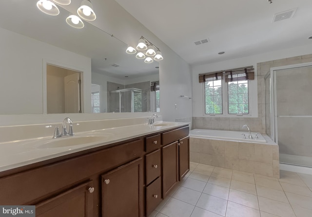 bathroom with tile patterned floors, visible vents, and a sink