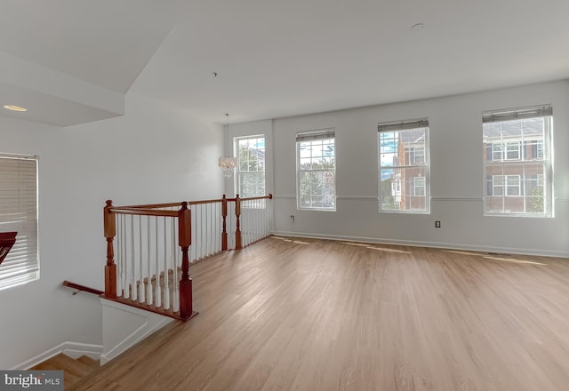 unfurnished room featuring baseboards and wood finished floors